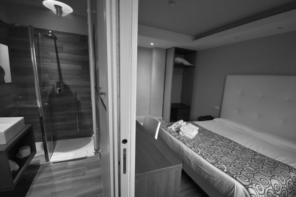 Postel nebo postele na pokoji v ubytování Hotel Riposo