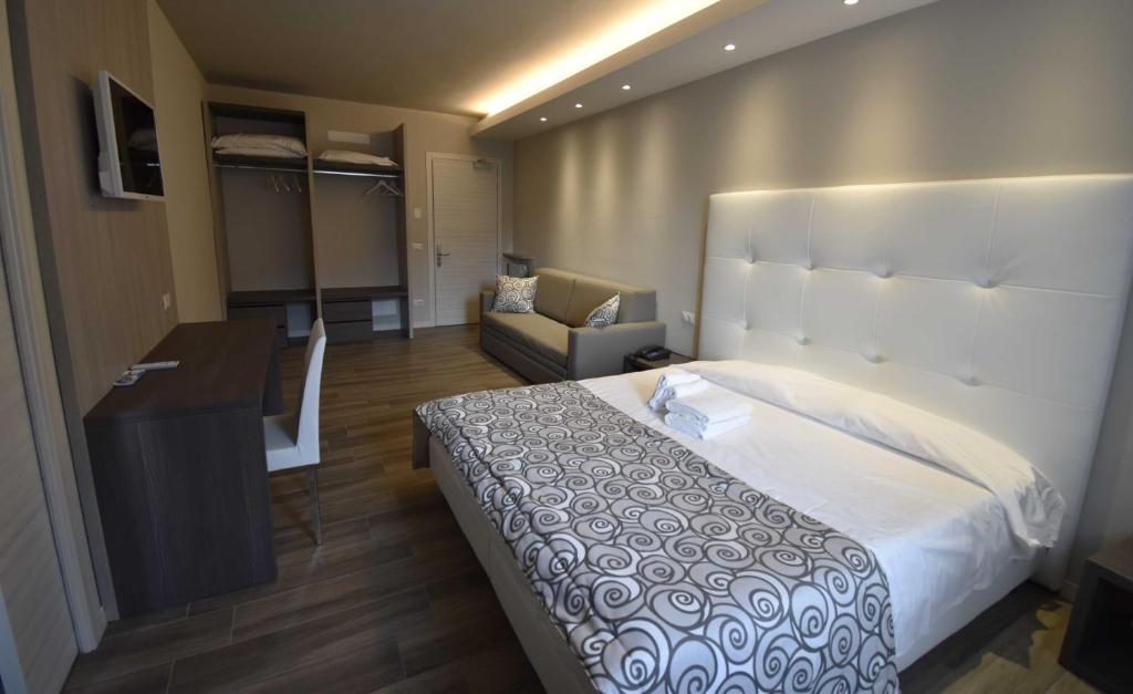 Postel nebo postele na pokoji v ubytování Hotel Riposo