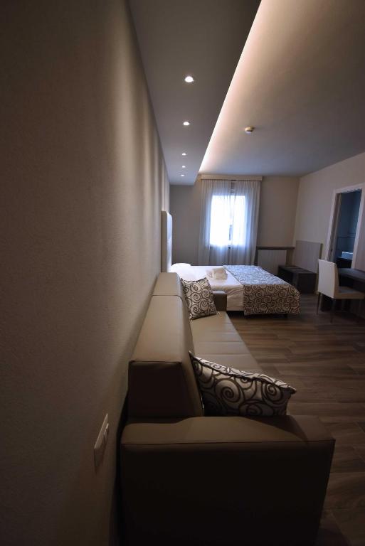Postel nebo postele na pokoji v ubytování Hotel Riposo