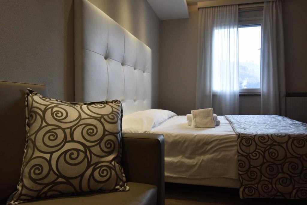 Postel nebo postele na pokoji v ubytování Hotel Riposo