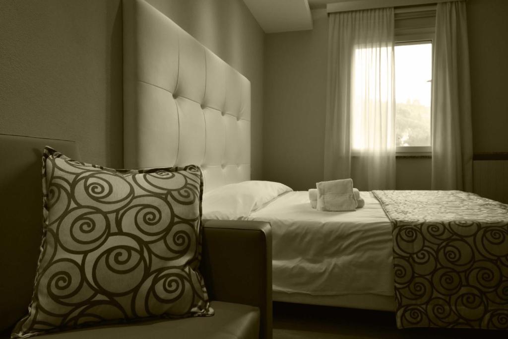 Postel nebo postele na pokoji v ubytování Hotel Riposo