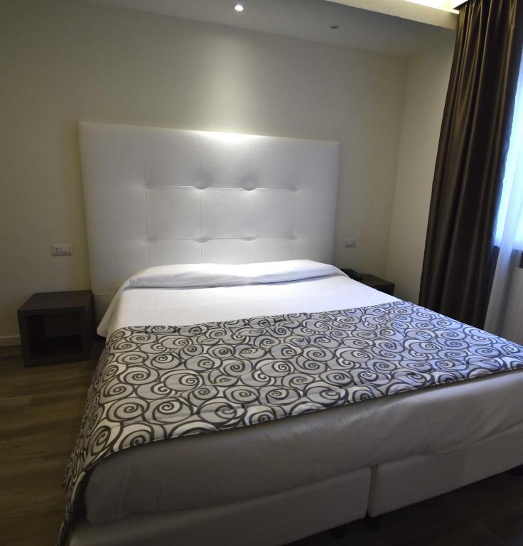 Postel nebo postele na pokoji v ubytování Hotel Riposo