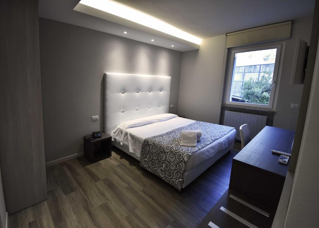 Postel nebo postele na pokoji v ubytování Hotel Riposo