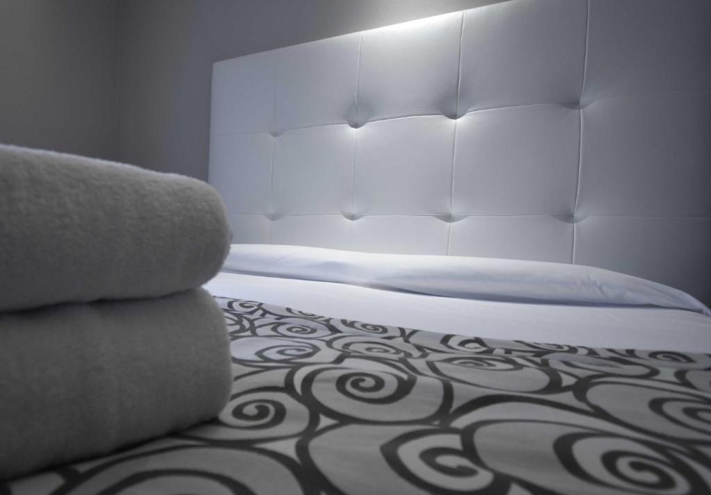 Postel nebo postele na pokoji v ubytování Hotel Riposo