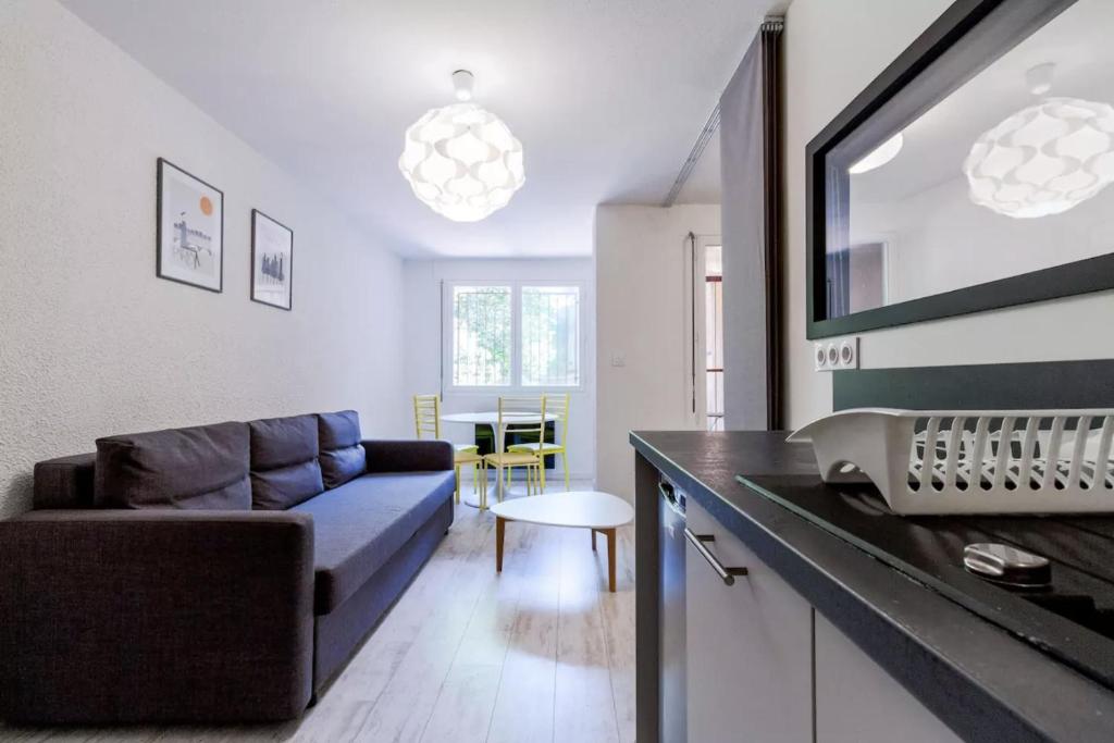 a living room with a couch and a table at T2 Design Hypercentre Capitole in Toulouse