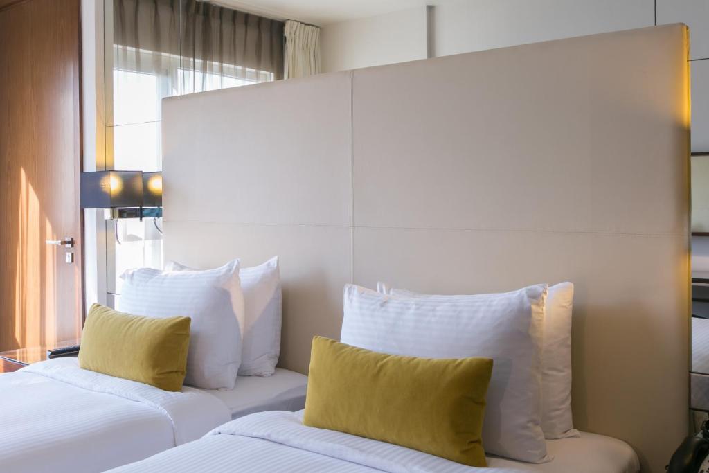 Postel nebo postele na pokoji v ubytování Centro Capital Doha - By Rotana