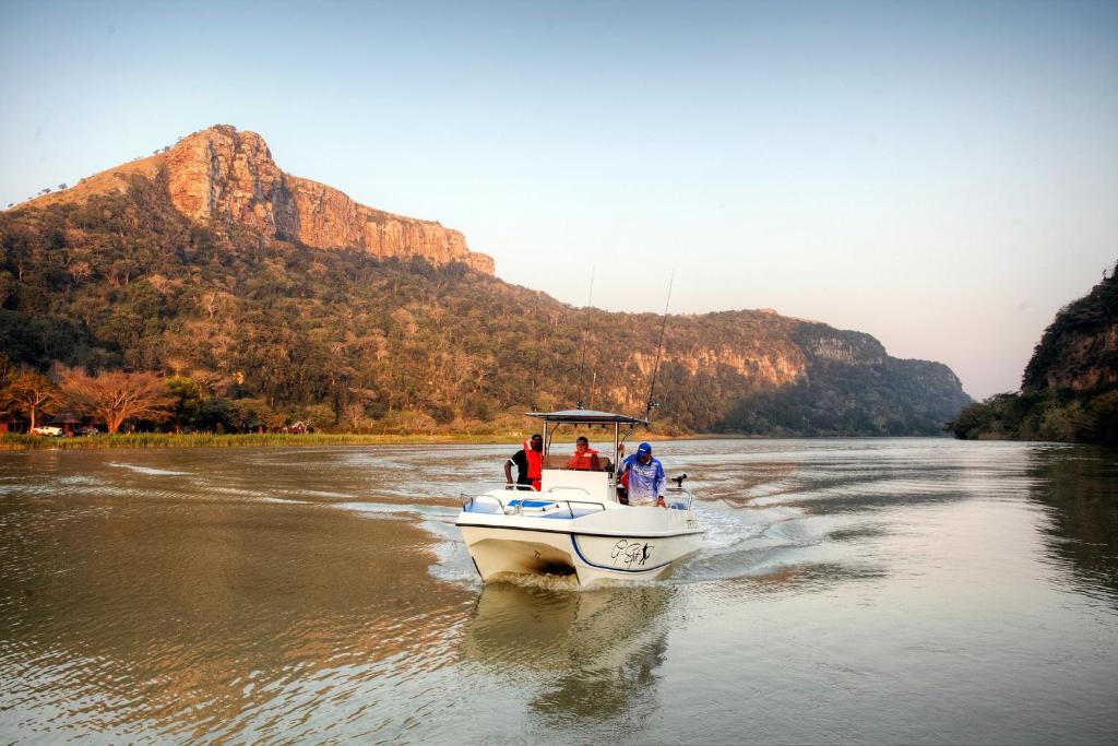 a group of people on a boat on a river at The Spotted Grunter Resort in Port St Johns