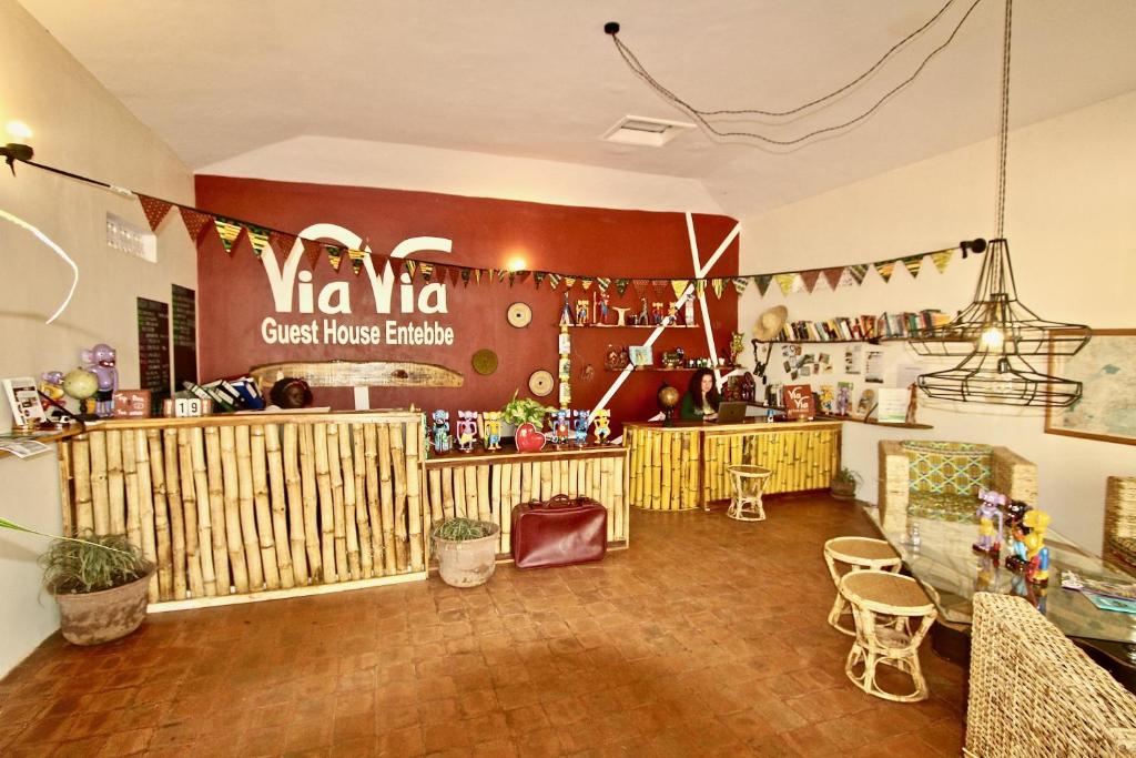a kitchen filled with lots of furniture and decor at ViaVia Entebbe in Entebbe