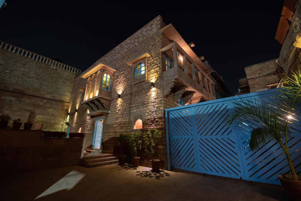 a building with a blue gate in front of it at night at Baijoo Niwas in Jodhpur