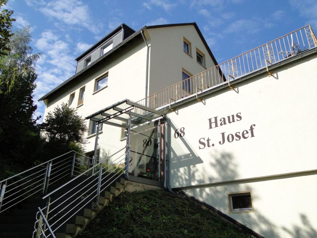 a white building with a staircase leading up to it at Haus St. Josef in Vallendar