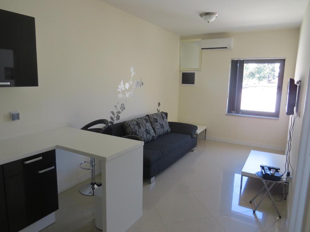 a living room with a couch and a table at Apartments Amfora in Biograd na Moru