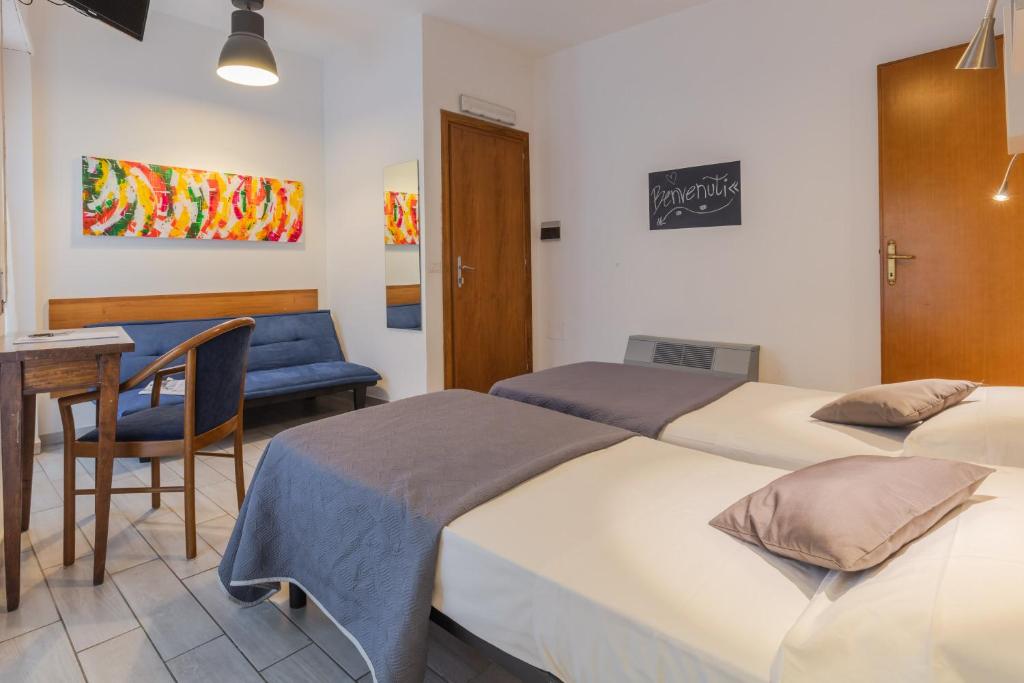 Postel nebo postele na pokoji v ubytování Hotel Viterbo Inn