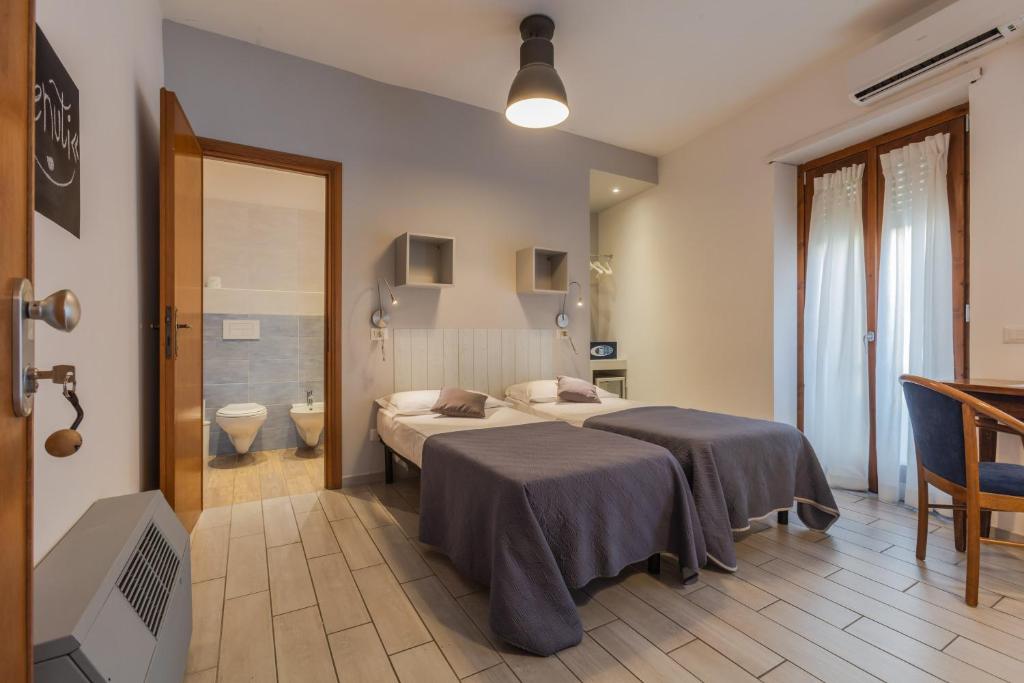 Postel nebo postele na pokoji v ubytování Hotel Viterbo Inn