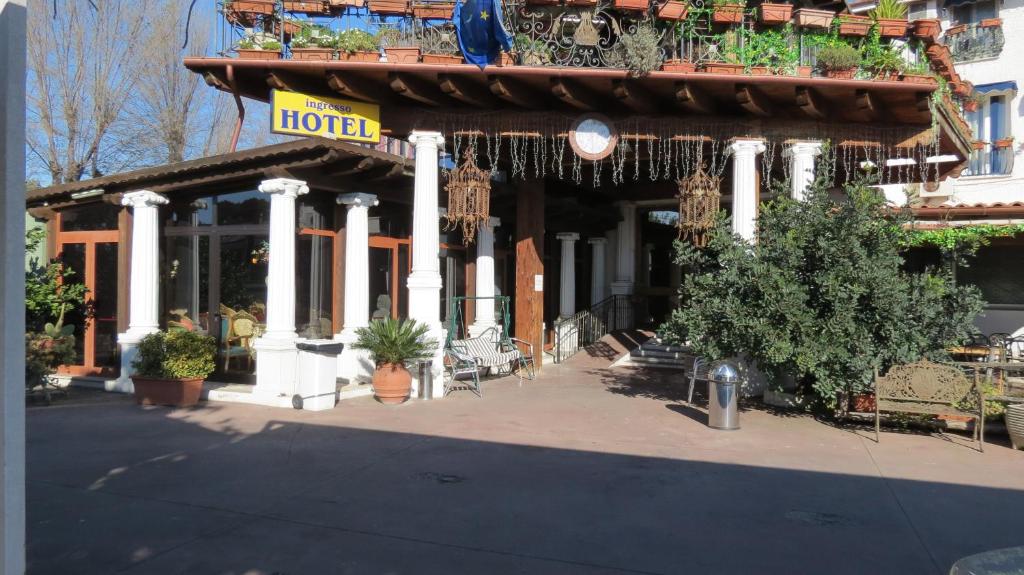 a hotel with potted plants on the front of it at Hotel Chopin in Fiumicino