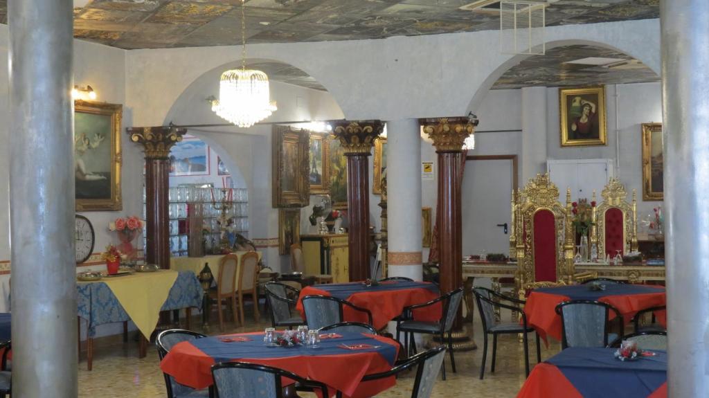 a restaurant with tables and chairs in a room at Hotel Chopin in Fiumicino