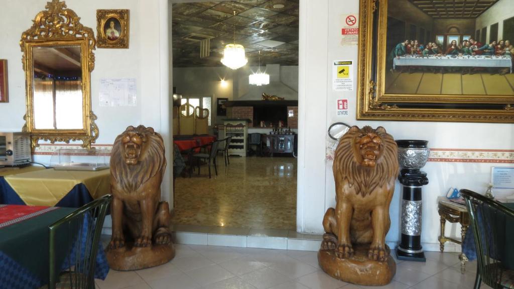 two statues of lions on the floor of a store at Hotel Chopin in Fiumicino