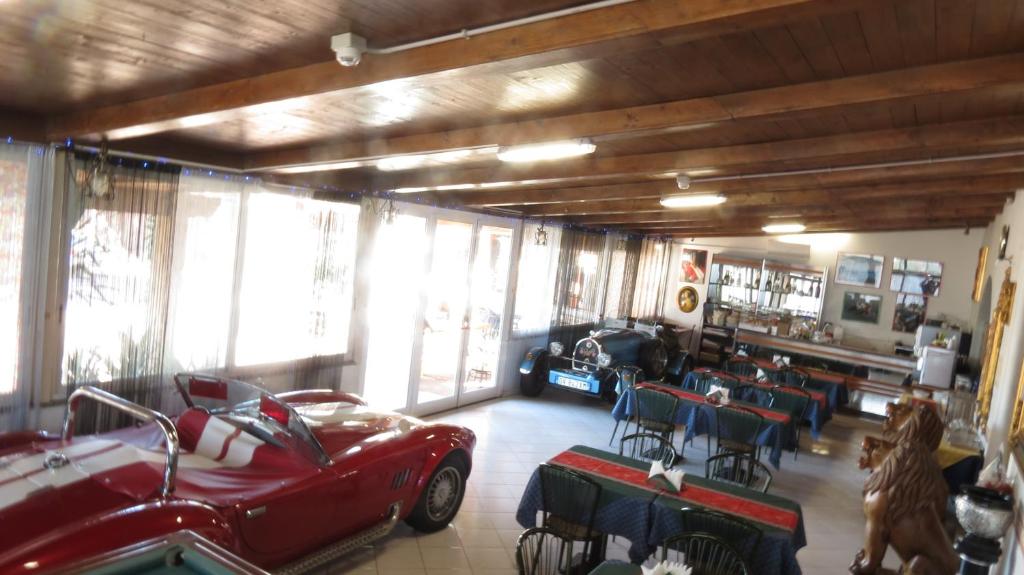 a room with a red car parked in a garage at Hotel Chopin in Fiumicino