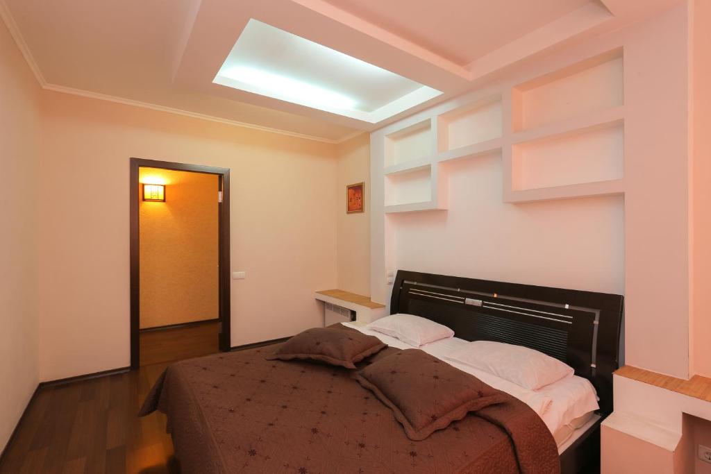 a bedroom with a bed and a skylight at Grata Apartments - Kiev in Kyiv