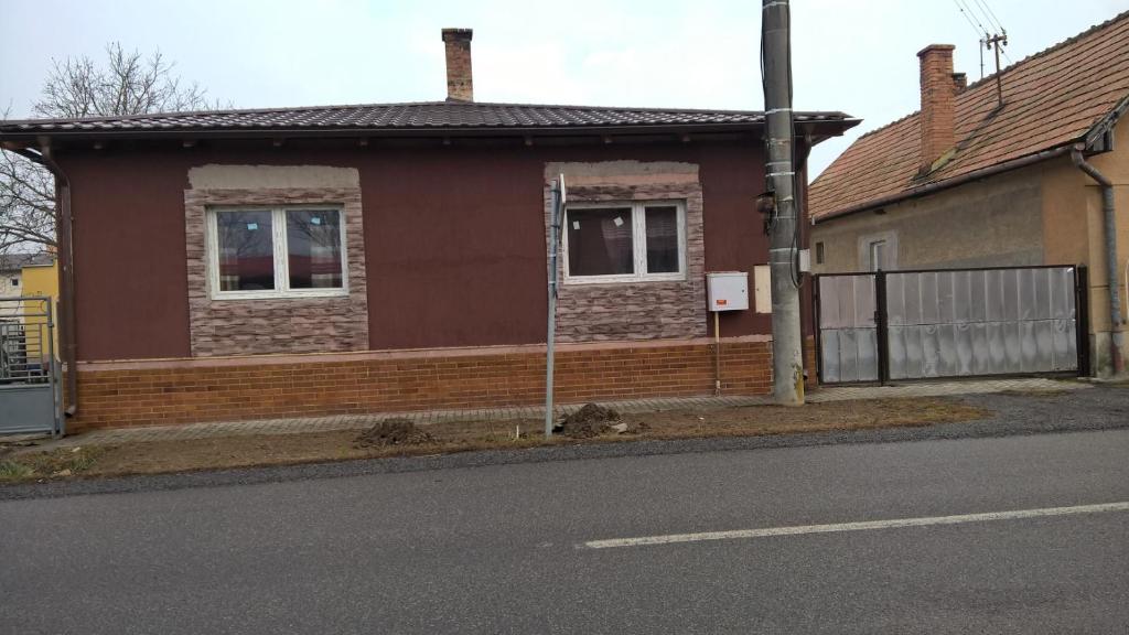 a brown house on the side of a street at rodiny dom in Rapovce