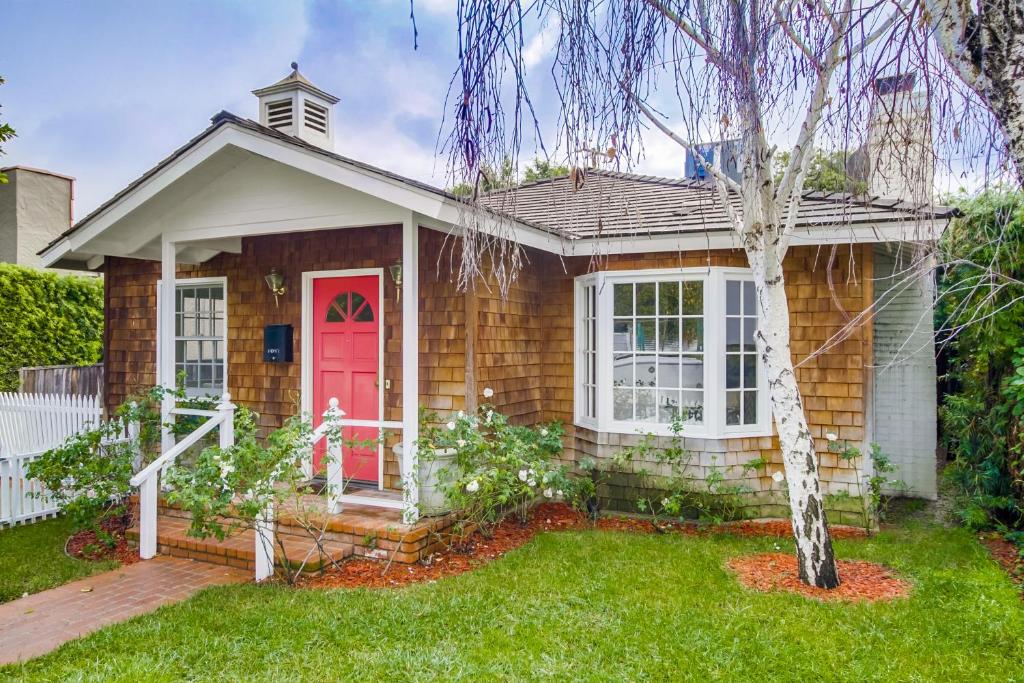 a small house with a red door at A Touch of Cape Cod in West Hollywood in Los Angeles