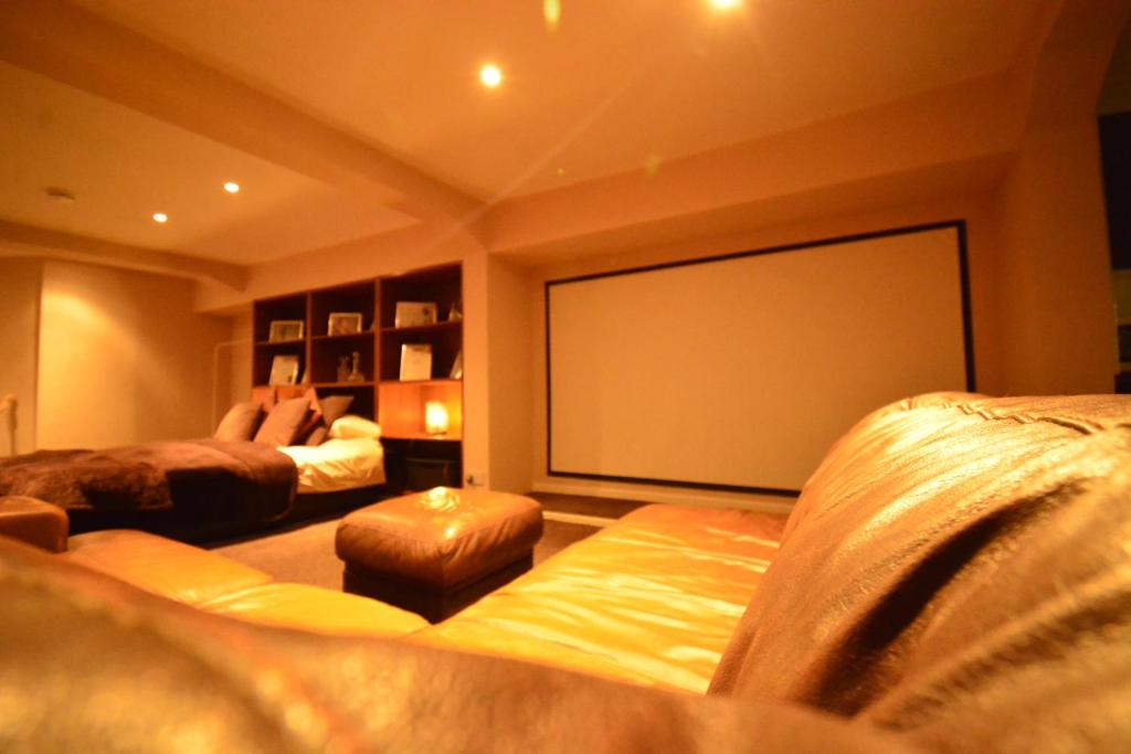 a room with two beds and a large projection screen at Aparthotel Glovers Court in Preston