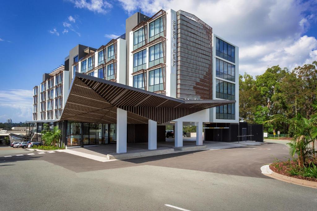 un gran edificio con un toldo marrón delante de él en Mantra at Sharks en Gold Coast