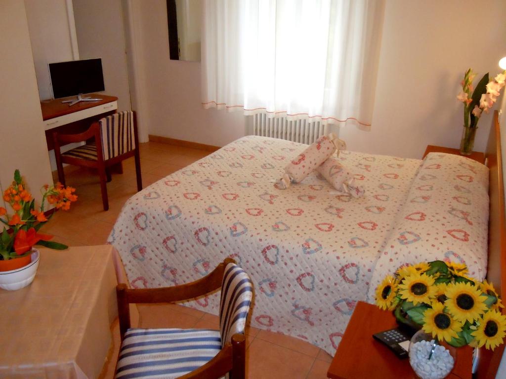 Postel nebo postele na pokoji v ubytování Albergo Elvira