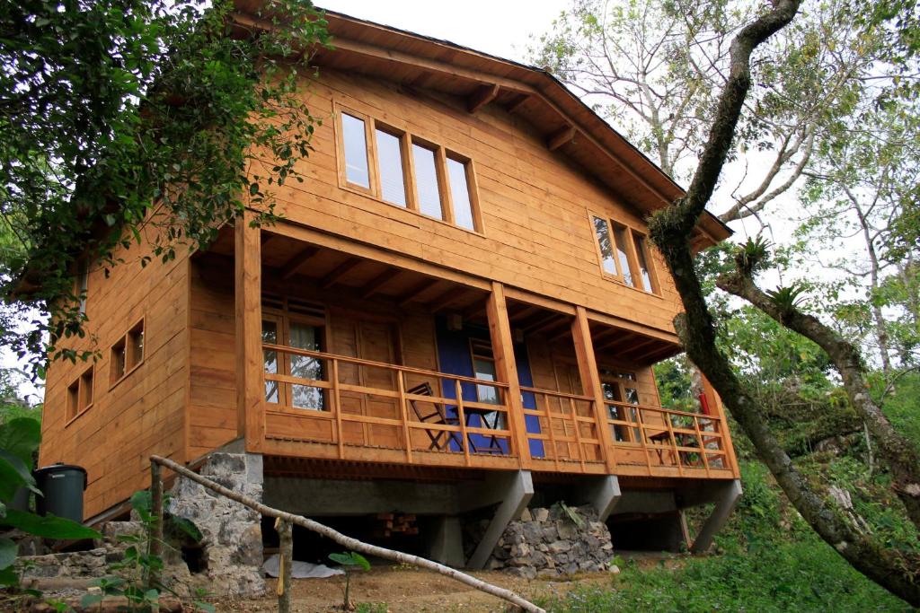 a large wooden house in the middle of a forest at Reserva Azul in Cuetzalán del Progreso