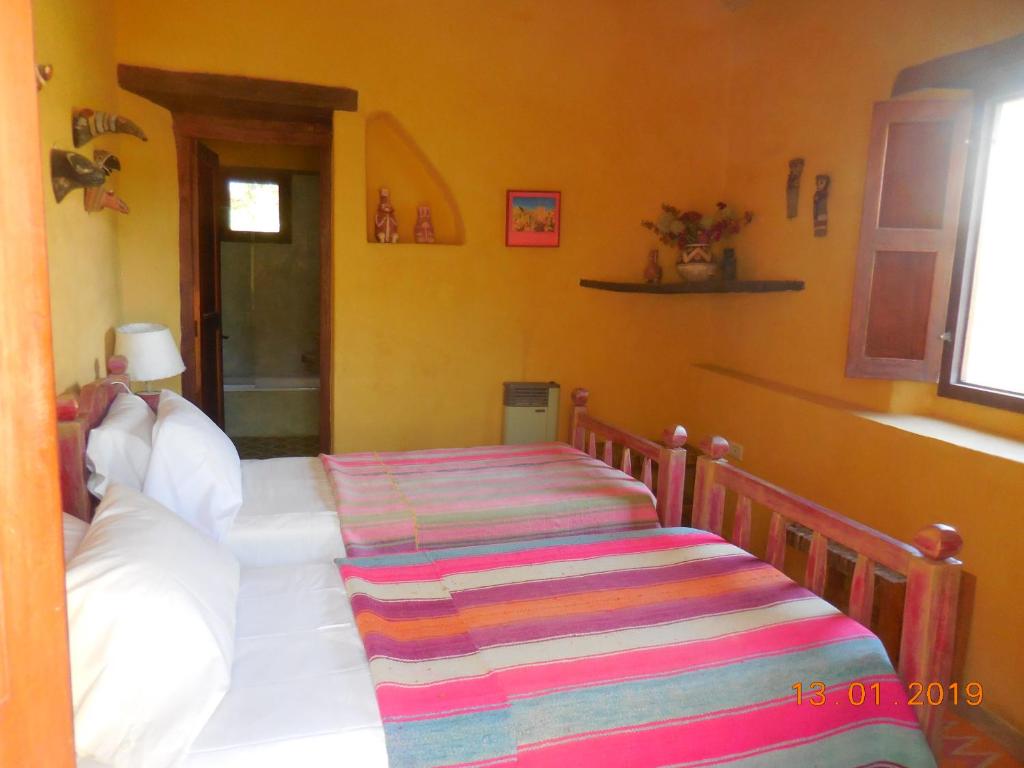 Una cama o camas en una habitación de Casa del Tejedor