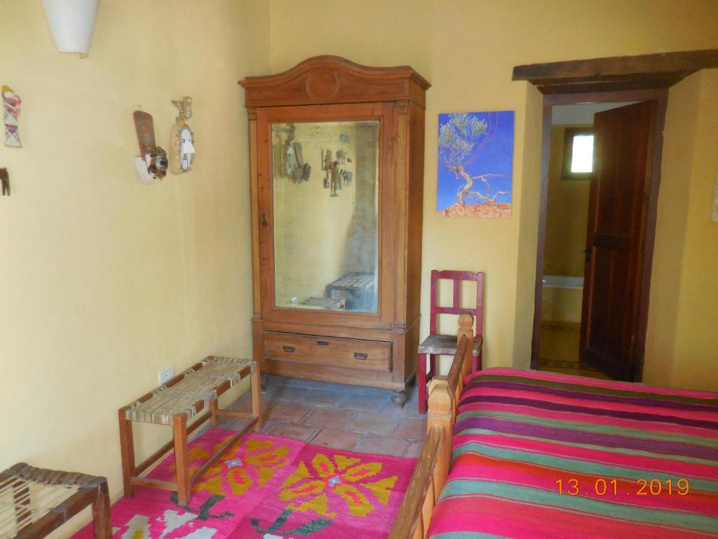Una cama o camas en una habitación de Casa del Tejedor