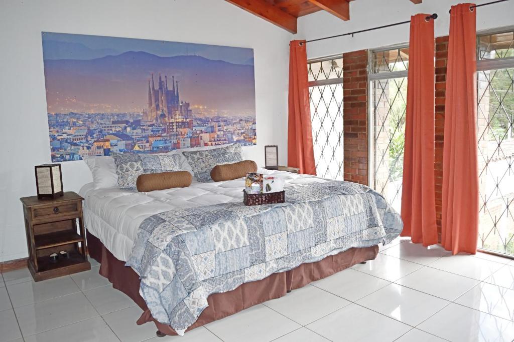 a bedroom with a bed and a large window at OH ESPAÑA! in Guatemala