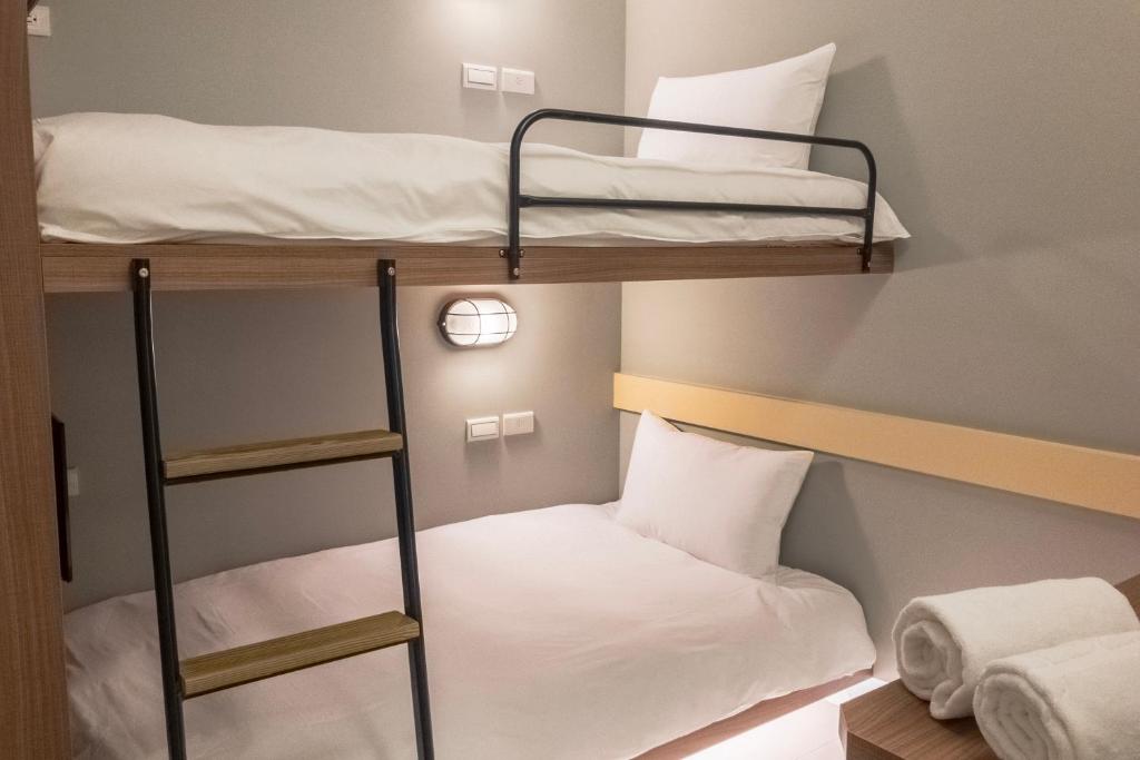 Postel nebo postele na pokoji v ubytování Divecube Hotel