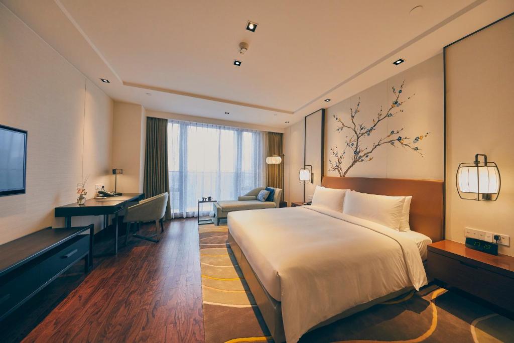 Postel nebo postele na pokoji v ubytování LJZ Supreme Tower Hotel