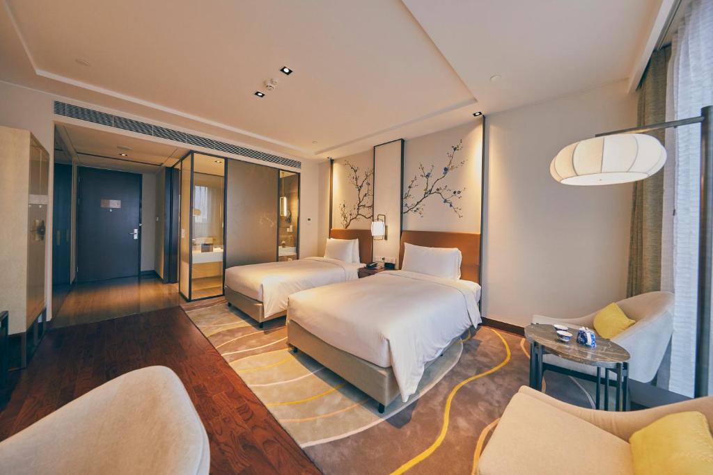 Postel nebo postele na pokoji v ubytování LJZ Supreme Tower Hotel