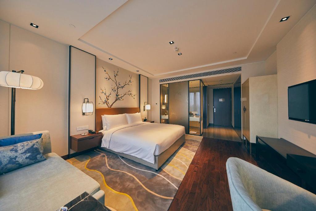 Postel nebo postele na pokoji v ubytování LJZ Supreme Tower Hotel