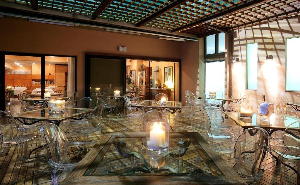 a room with tables and chairs with candles on them at Villa Maiella in Guardiagrele