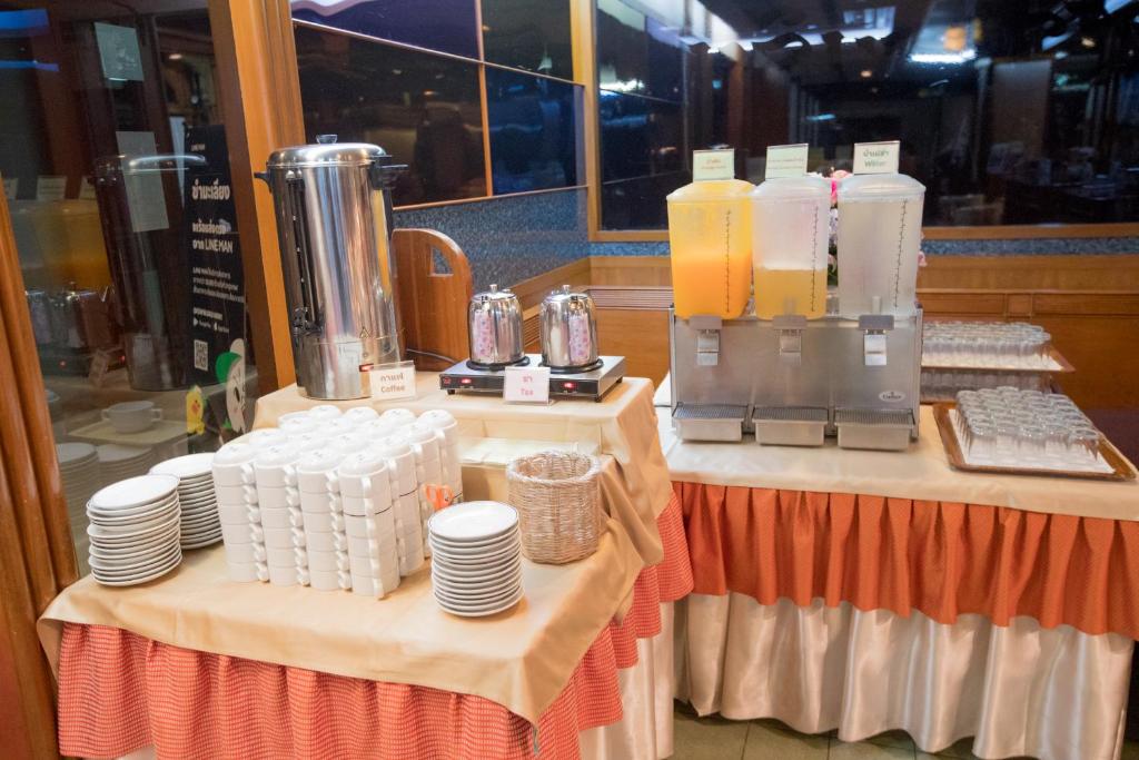 A larger breakfast drinks and crockery station beside windows.