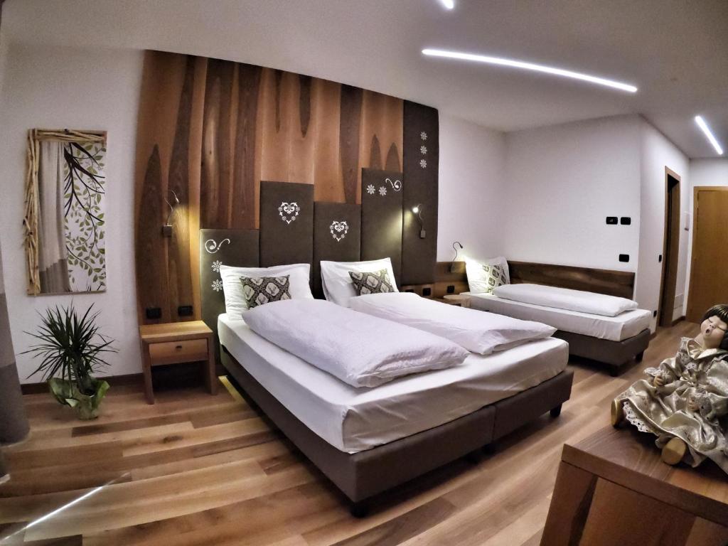 Postel nebo postele na pokoji v ubytování Hotel Cristallo