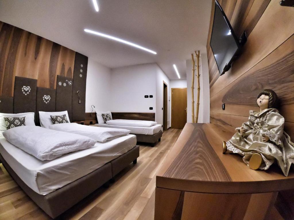 Postel nebo postele na pokoji v ubytování Hotel Cristallo