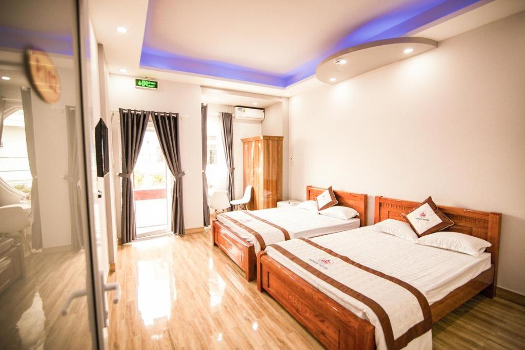 a hotel room with two beds in a room at SUNNY HOTEL in Quy Nhon