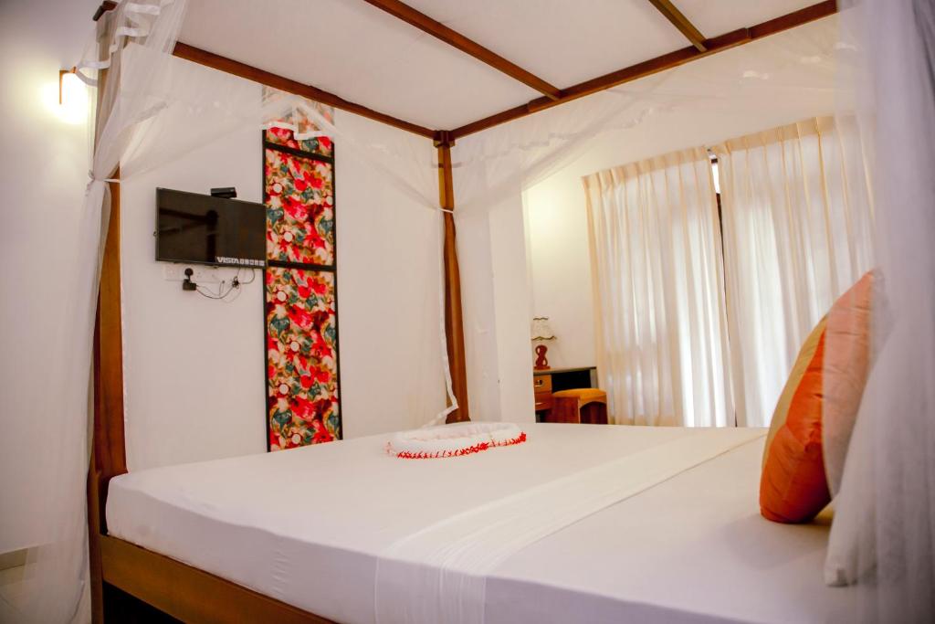 Postel nebo postele na pokoji v ubytování Prince Beach Hotel Bentota