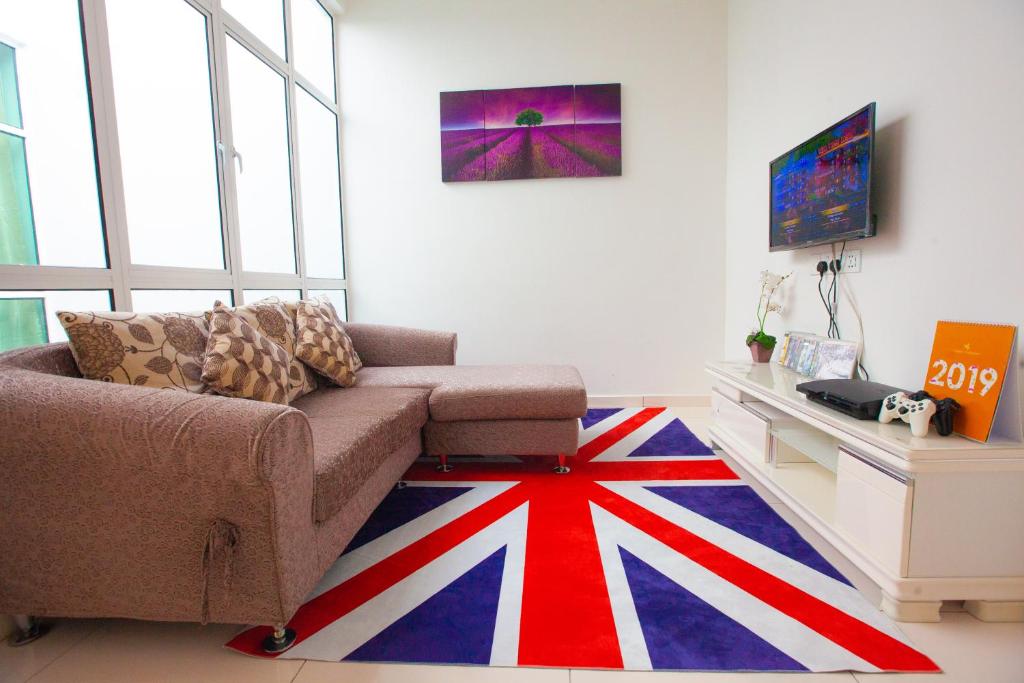 a living room with a couch and a flag rug at THE ONLY SEA VIEW IN TOWN in Kuah