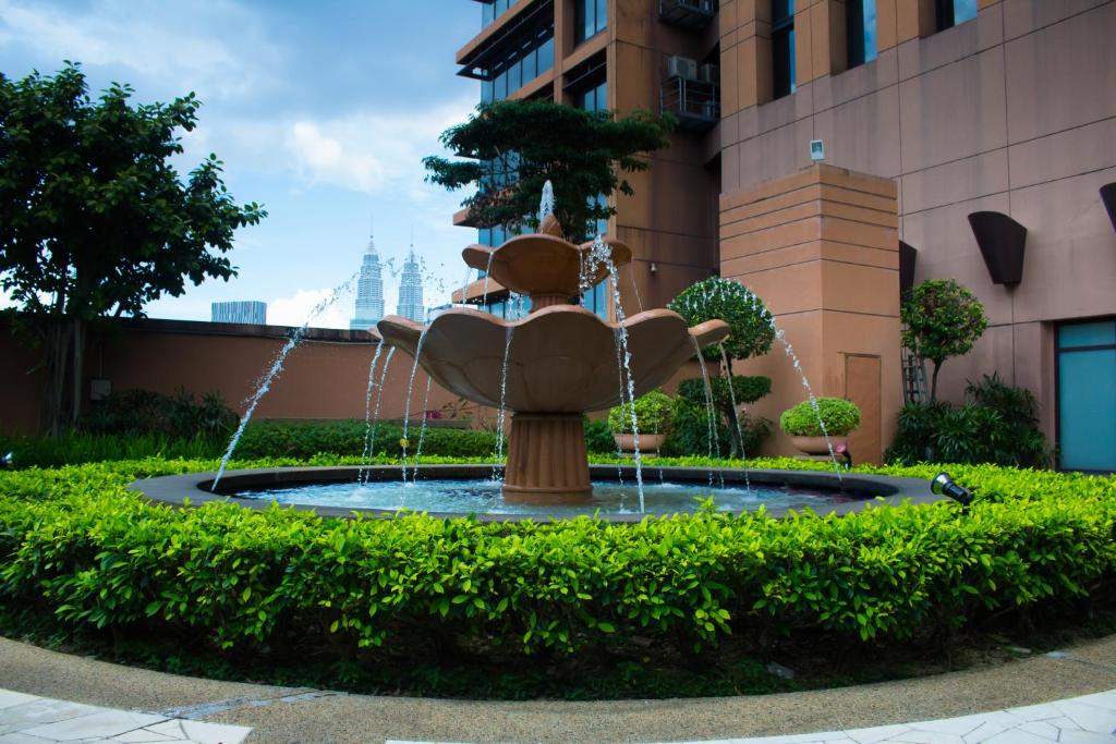 a fountain in the middle of a building at The Apartments at Times Square Kuala Lumpur KL in Kuala Lumpur