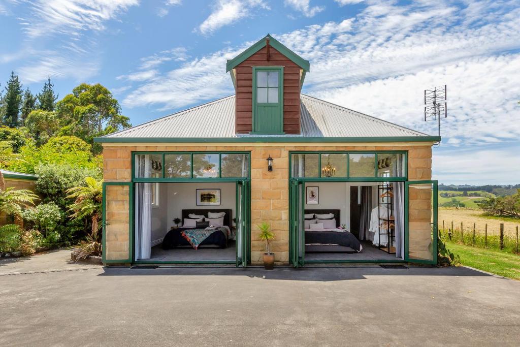 a small house with two beds inside of it at Deloraine Stone Cottage in Whangarei