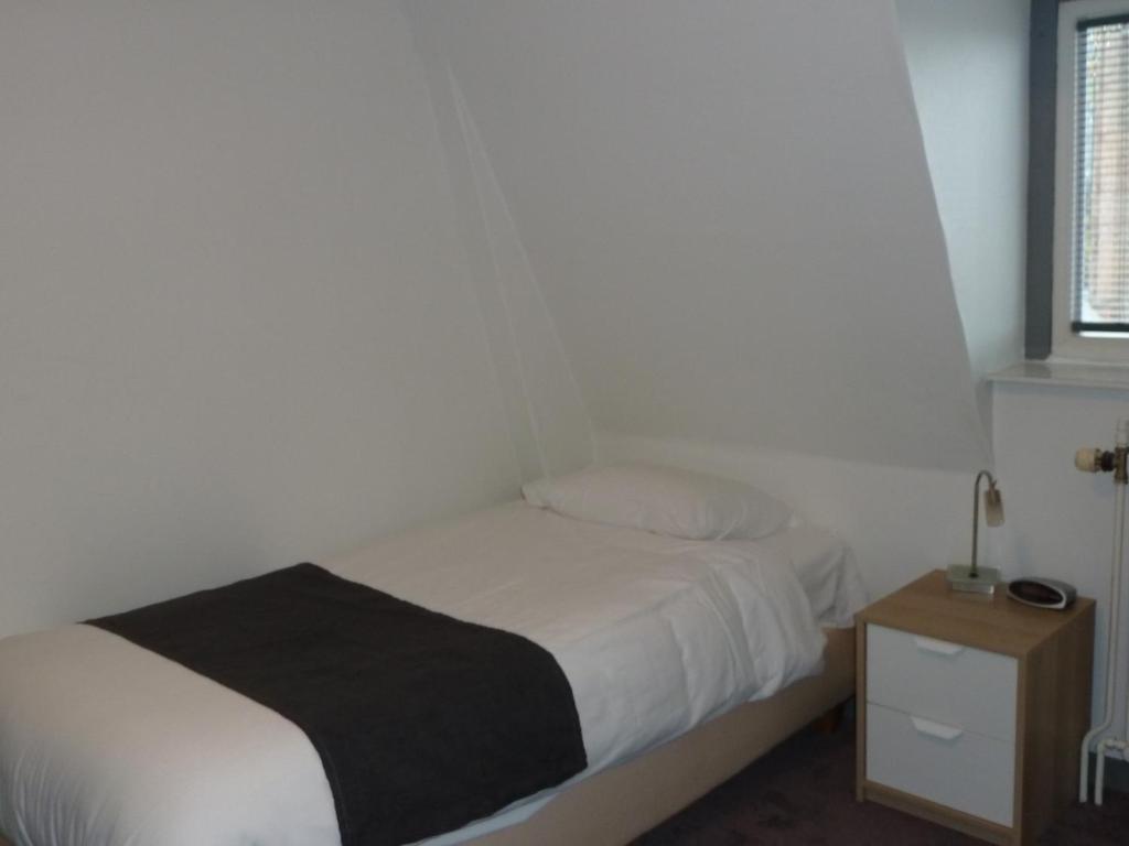 Postel nebo postele na pokoji v ubytování Hotel Centraal