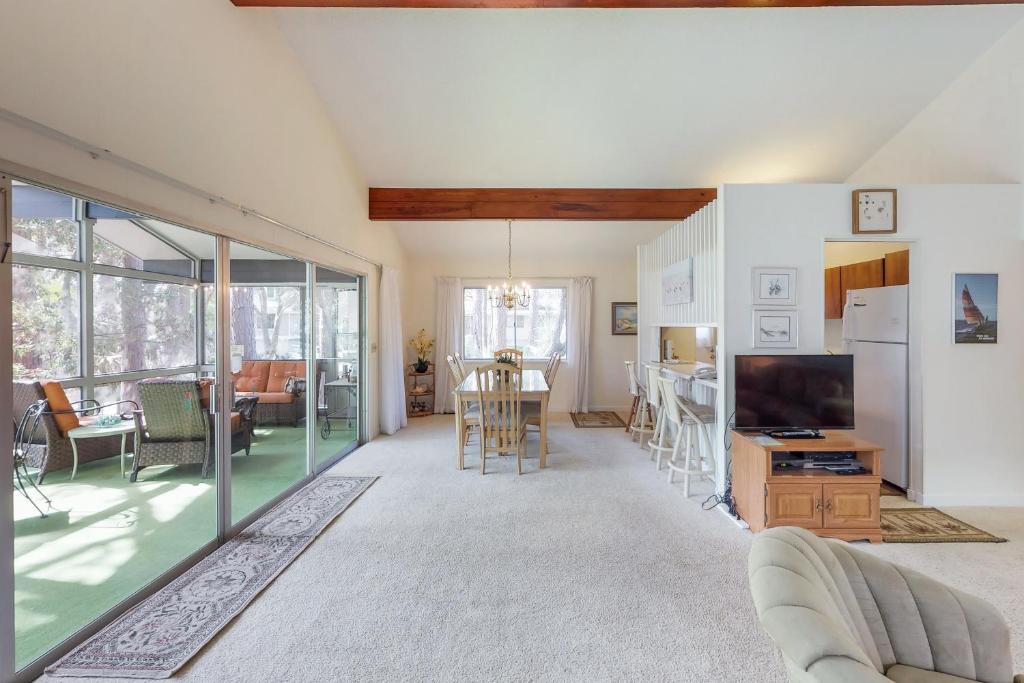 a living room with a couch and a tv at Island Pearl in Hilton Head Island