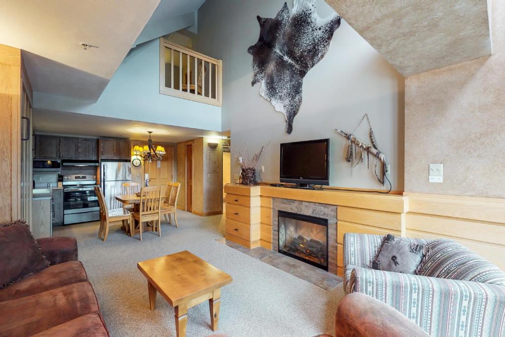 a living room with a couch and a fireplace at Shoshone 1993 in Big Sky