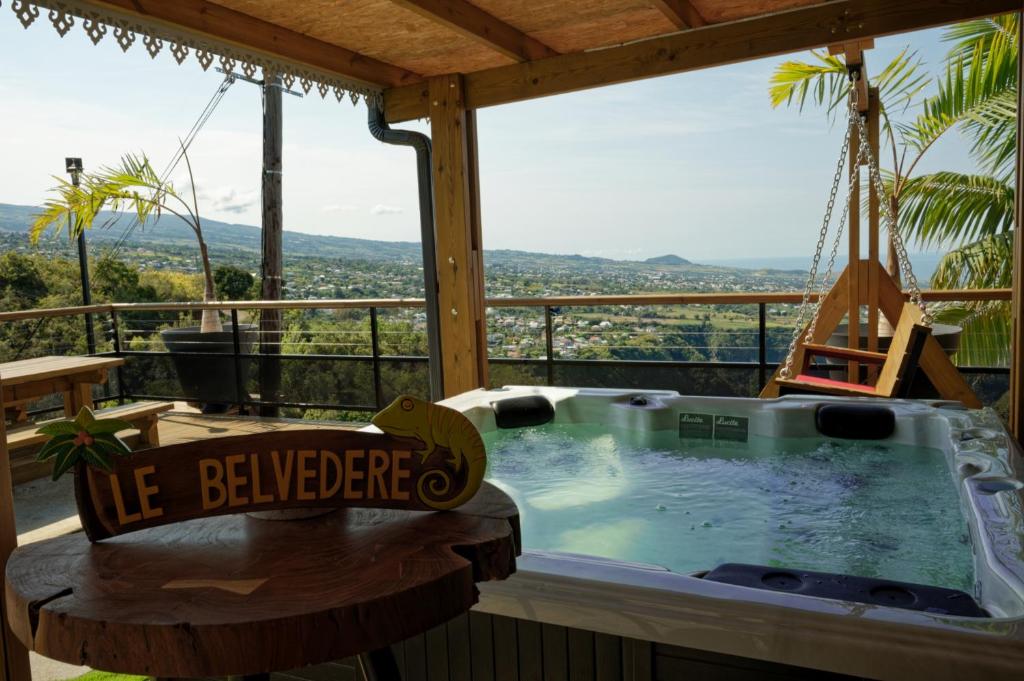 a jacuzzi tub in a house with a view at LE BELVÉDÈRE in LʼEntre-Deux