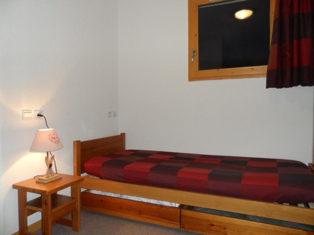 1 dormitorio con 1 cama y TV en la pared en " B18 " T2-5p de standing au pied des pistes de Superdévoluy - "résidence Les Toits du Dévoluy" - Vue Magnifique - classé PMR en Saint-Étienne-en-Dévoluy