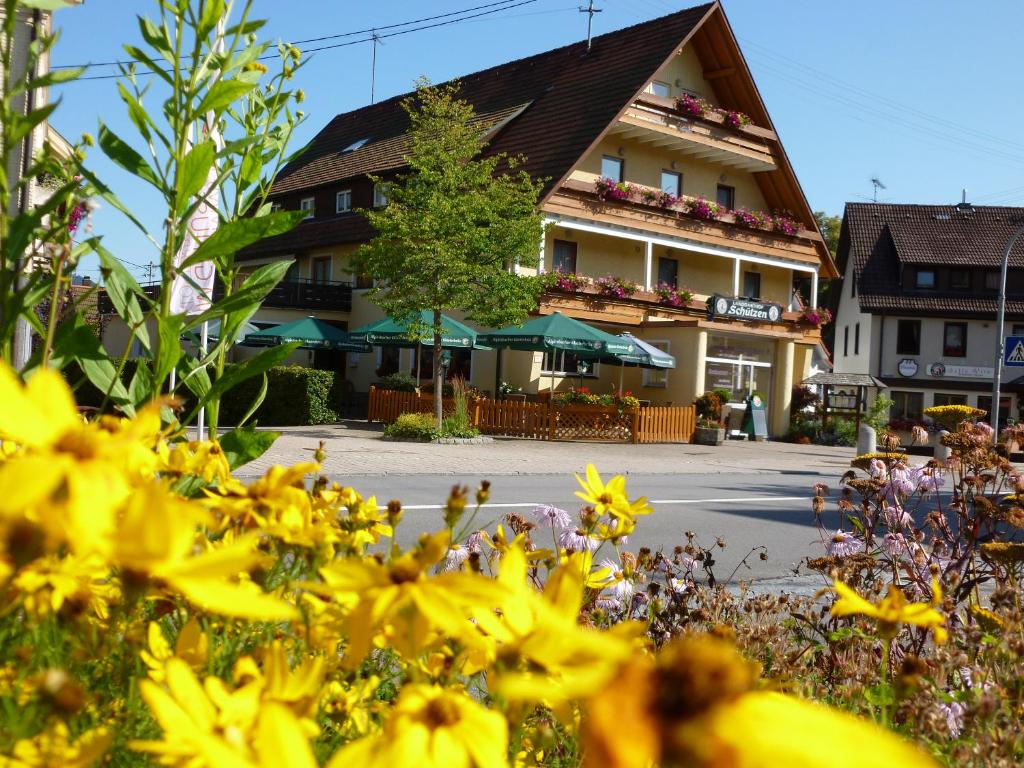 um edifício com flores amarelas em frente em Hotel-Restaurant Gasthof zum Schützen em Baiersbronn